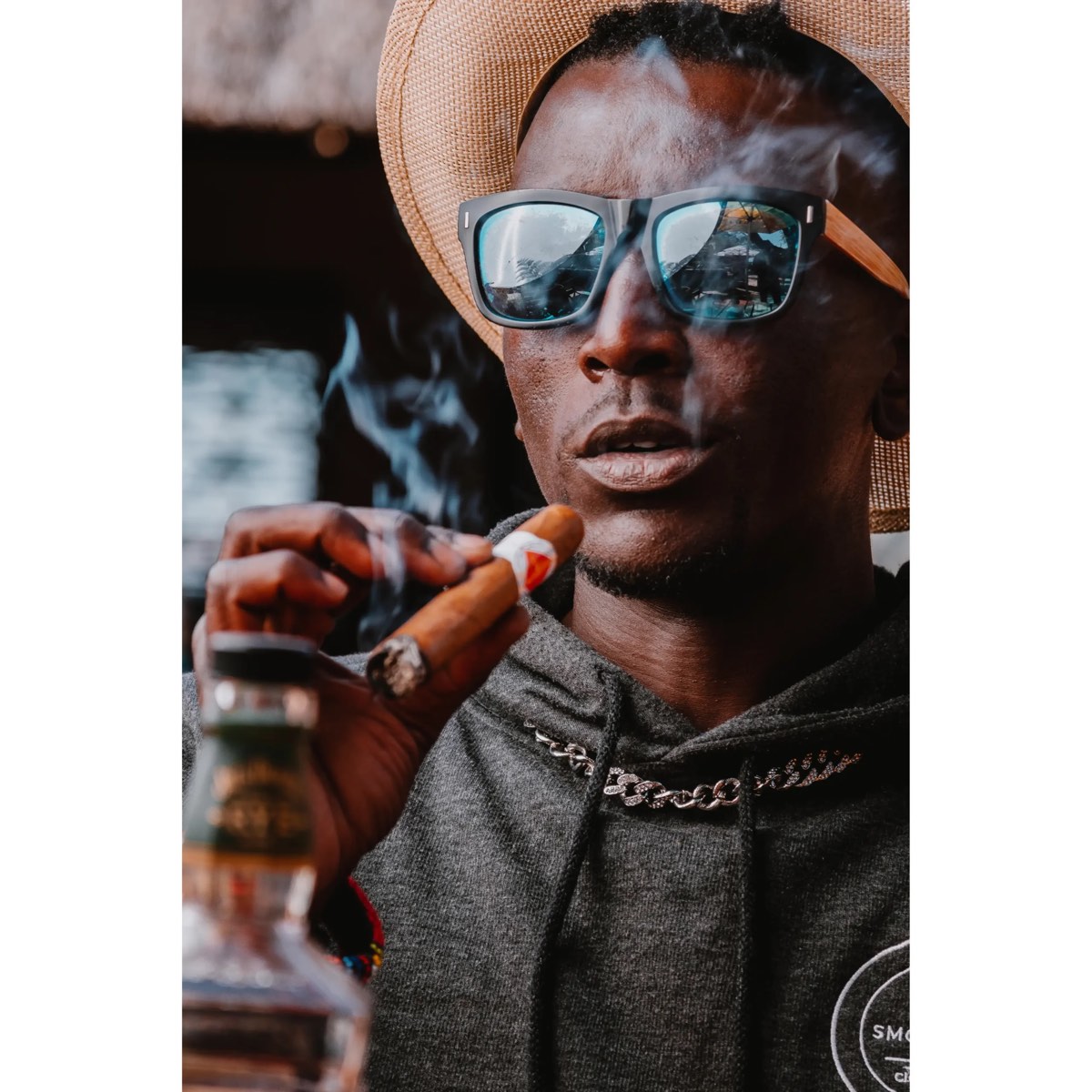 Man holding a lit handmade premium Bongani Robusto cigar